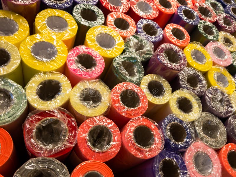 Rolls of decorative wrapping paper of different colors are on the store shelf royalty free stock photos