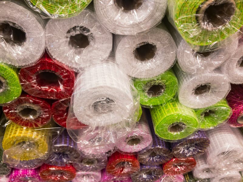 Rolls of textured decorative wrapping paper of different colors on the shelf in the store royalty free stock photos