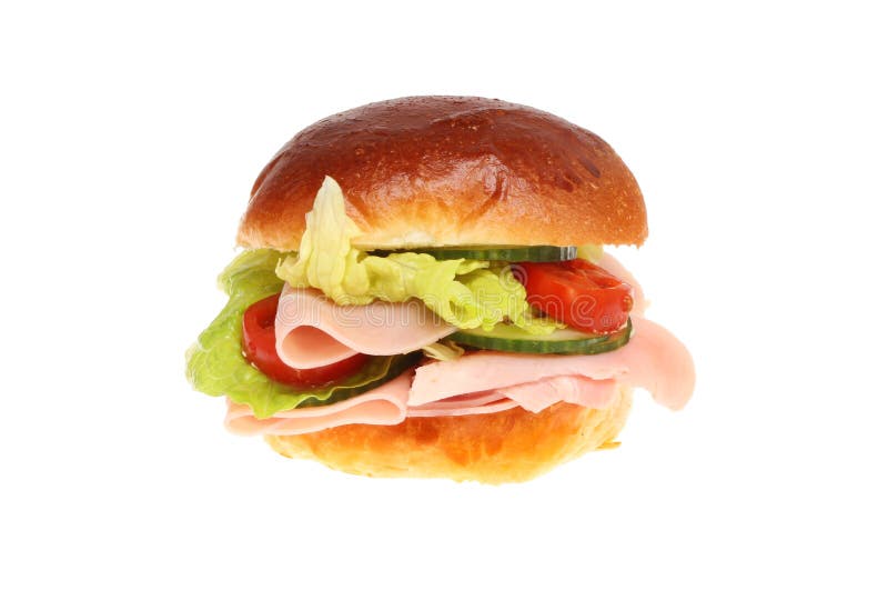 Ham and salad in a brioche roll against white. Ham and salad in a brioche roll against white