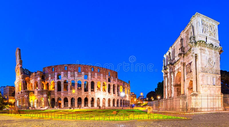 Roma, Italia: Vista di notte dell'arco di Costantina accanto al Colosseum dopo il tramonto sopra un cielo blu immagini stock Roma, Italia: Vista di notte dell'arco di Costantina accanto al Colosseum dopo il tramonto sopra un cielo blu immagini stock