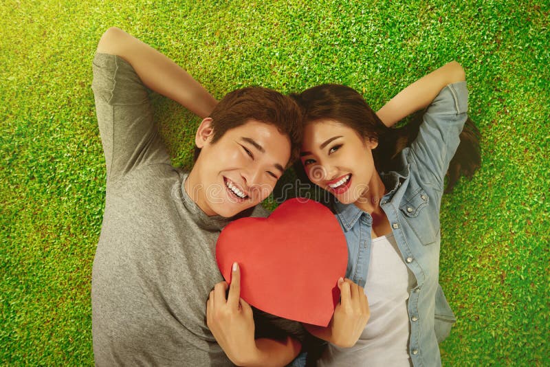 Romantic asian couple holding heart shape stock image Romantic asian couple holding heart shape stock image