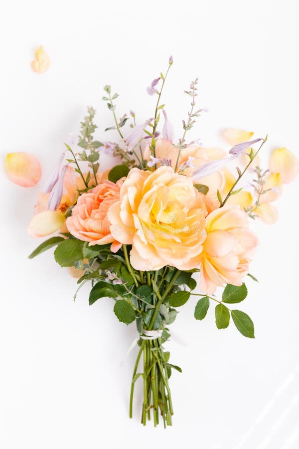 Romantic bouquet of orange English roses on a white background.