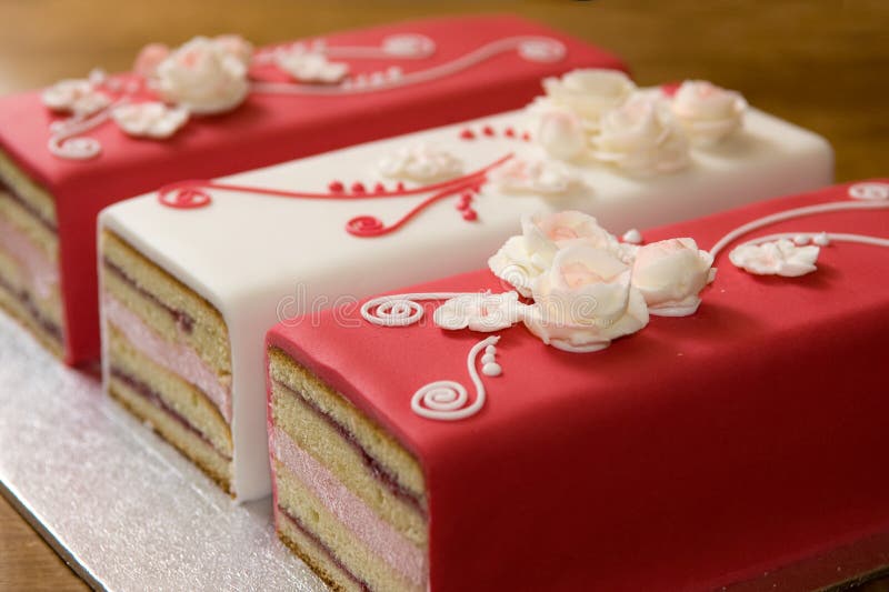 Romantic Cakes. Three beautiful pink and white cakes in a row, beautiful decorated with handmade romantic sugar roses and swirls Romantic Cakes. Three beautiful pink and white cakes in a row, beautiful decorated with handmade romantic sugar roses and swirls