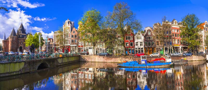 Romantic canalas of Amsterdam. Travel in Holland. Traditional colorful houses and canals in Amsterdam town,Holland