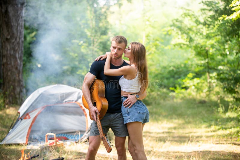 Romantic Couple On Camping Outdoor Adventure With Friends On Nature