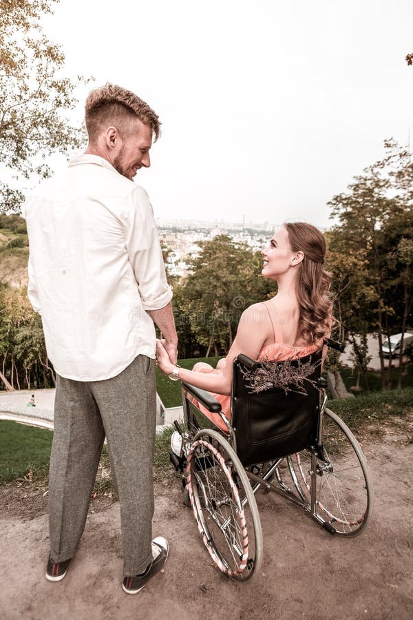 Romantic couple of disabled girl and young man looking happy and smiling royalty free stock images Romantic couple of disabled girl and young man looking happy and smiling royalty free stock images