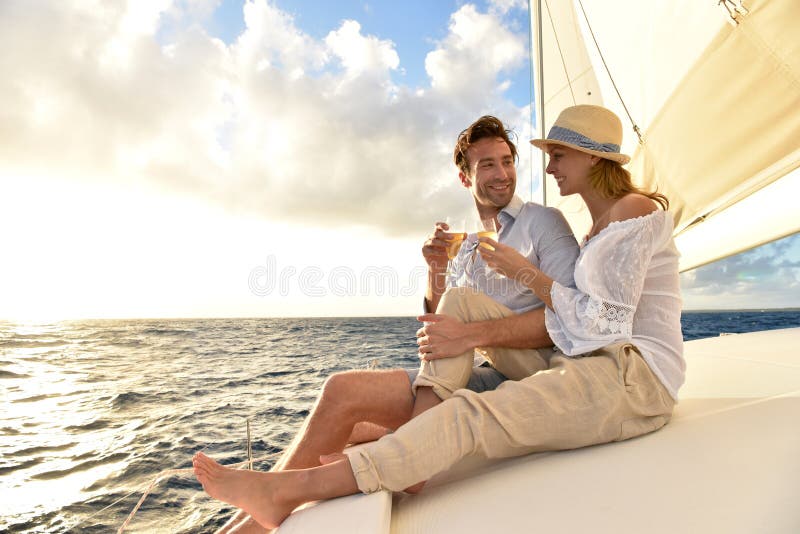 Romantic couple drinking champagne on sailing boat