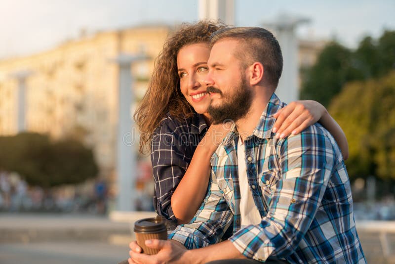 Romantic couple enjoying sunset and coffee outdoors royalty free stock photos