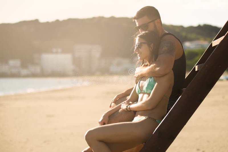 Romantic couple in hug watching sunrise/ sunset together.Young man and woman in love stock images Romantic couple in hug watching sunrise/ sunset together.Young man and woman in love stock images