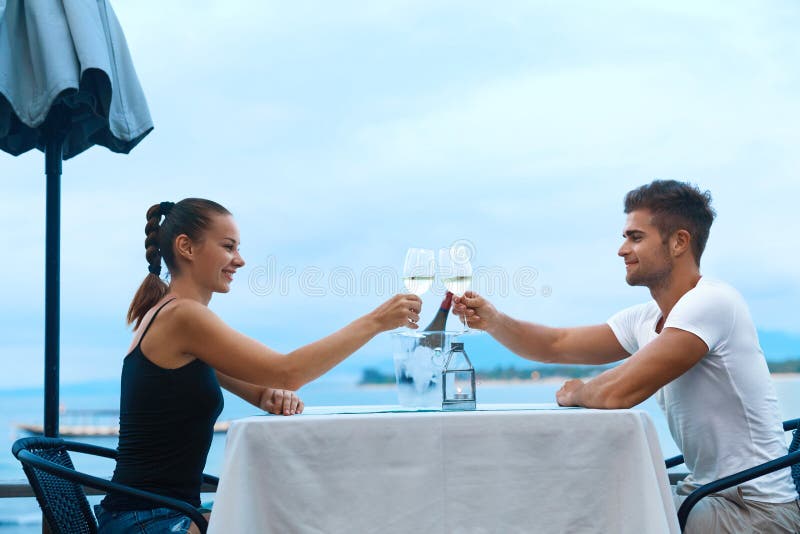 Romantic Couple In Love Having Dinner At Sea Beach Restaurant royalty free stock photo Romantic Couple In Love Having Dinner At Sea Beach Restaurant royalty free stock photo