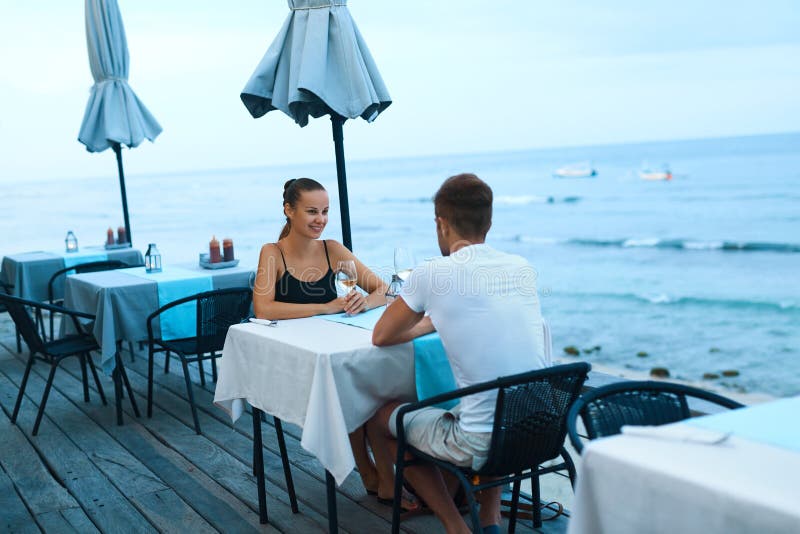 Romantic Couple in Love Having Dinner at Sea Beach Restaurant Stock