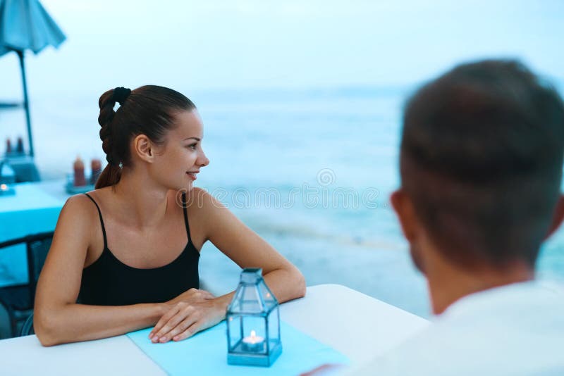 Romantic Couple in Love Having Dinner at Sea Beach Restaurant Stock