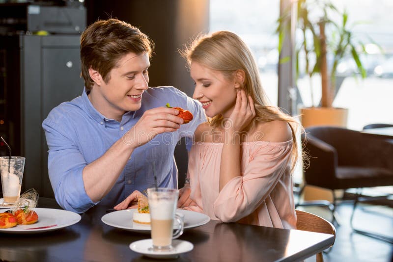 Romantic Couple in Love Having Lunch Together in Restaurant Stock Photo