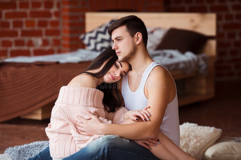 Romantic couple. Passion time. Young loving couple embracing and looking to each other at home. royalty free stock photography Romantic couple. Passion time. Young loving couple embracing and looking to each other at home. royalty free stock photography
