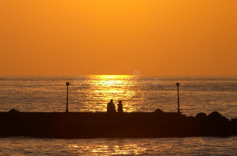 Romantic couple on a pier royalty free stock photography