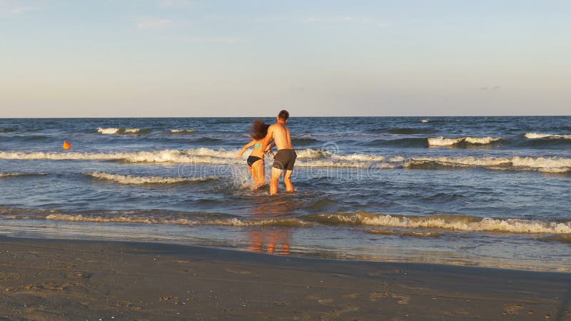 Beautiful Romantic Young Couple Teasing One Another and Playing by the