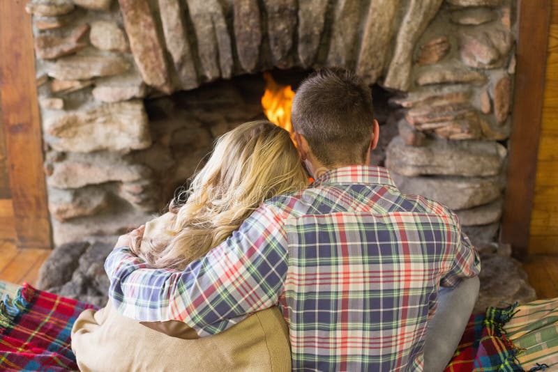 Romantic Couple Sitting in Front of Lit Fireplace Stock Photo Image