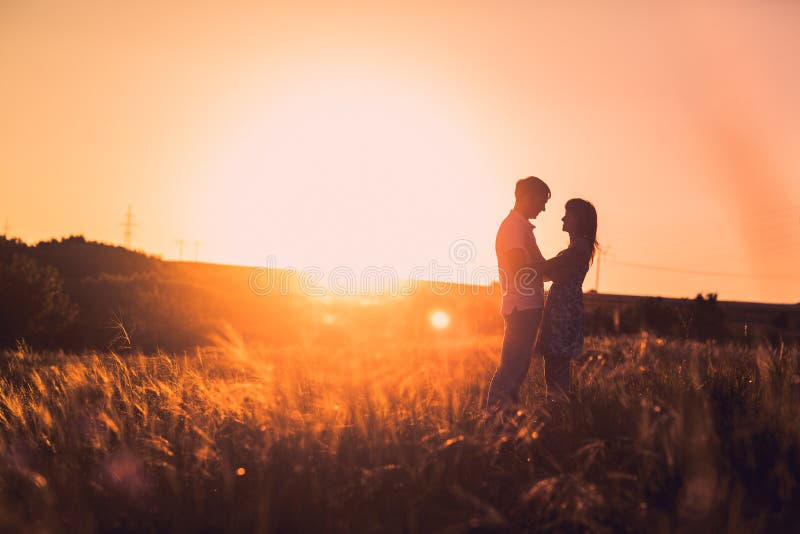 Romantic Couple Standing And Kissing On Background Summer Meadow Sunset ...