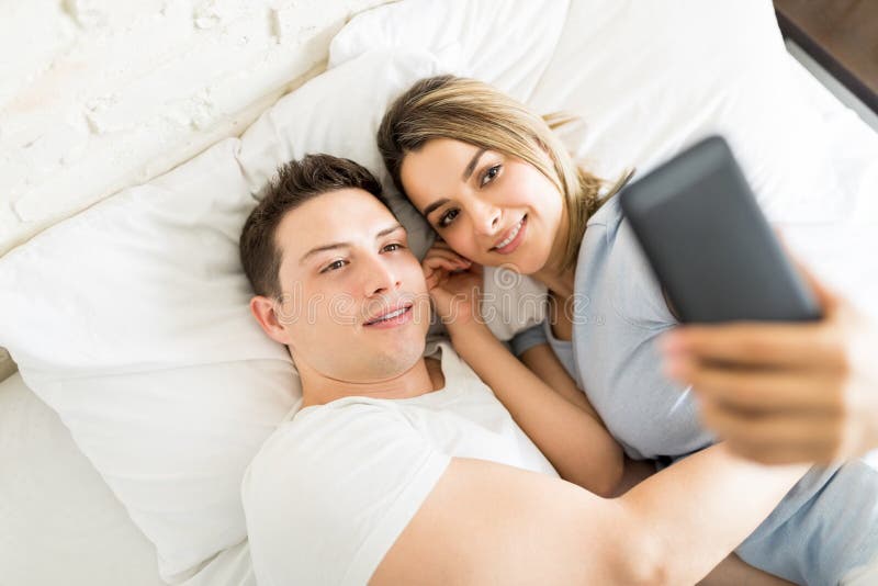 Romantic Couple Taking Selfie On Phone While Lying On Bed Stock Image Image Of High Love 