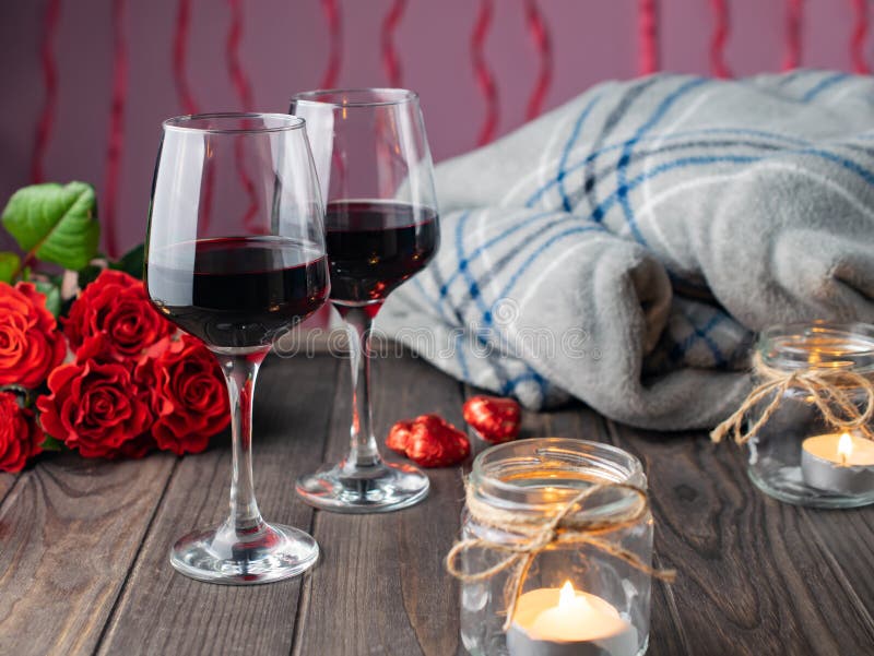 Romantic Cozy Evening with Wine, Flowers, Candles and Present Stock