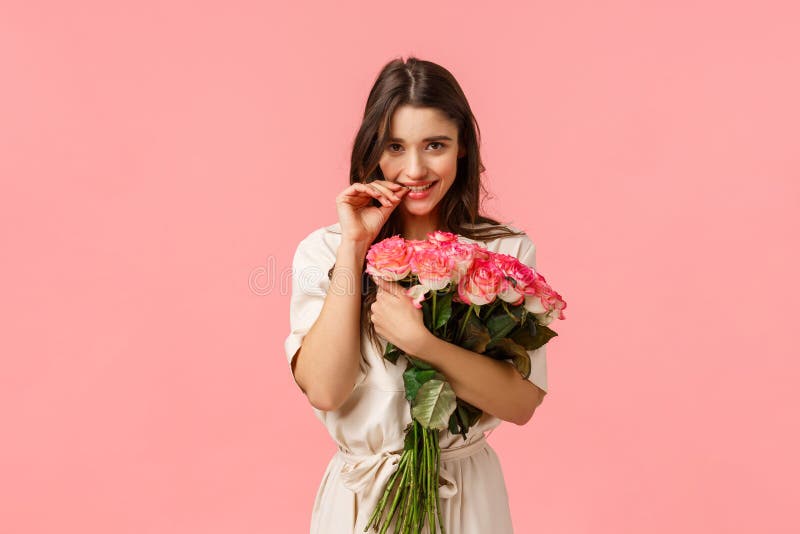 Romantic date, beauty and fashion concept. Gorgeous brunette girl in dress, receive beautiful bouquet flowers, got roses