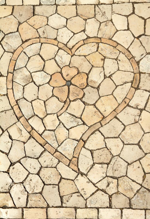 Traditional portuguese decorative small tiles mosaic with heart and flower on pavement in Belem , Lisbon,Portugal, Europe. Traditional portuguese decorative small tiles mosaic with heart and flower on pavement in Belem , Lisbon,Portugal, Europe