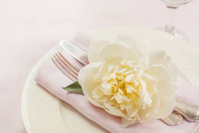 Romantic dinner. Table setting on pink linen tablecloth. Top view.