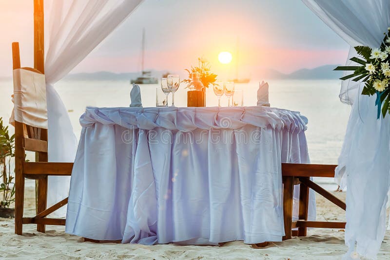 Romantic Dinner Table on the Tropical Beach, during Sunset, Ships in