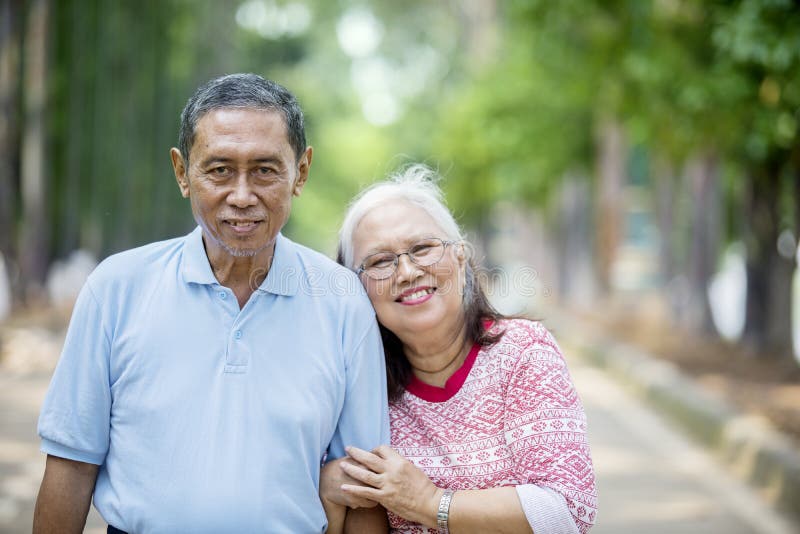 Romantic elderly couple standing on the road stock image Romantic elderly couple standing on the road stock image
