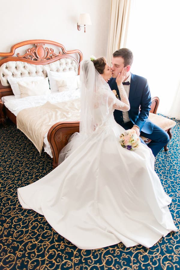 Romantic Kiss Happy Bride And Groom In Bedroom On Wedding