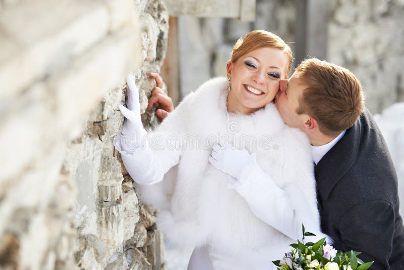 Romantic kiss happy bride and groom on wedding day