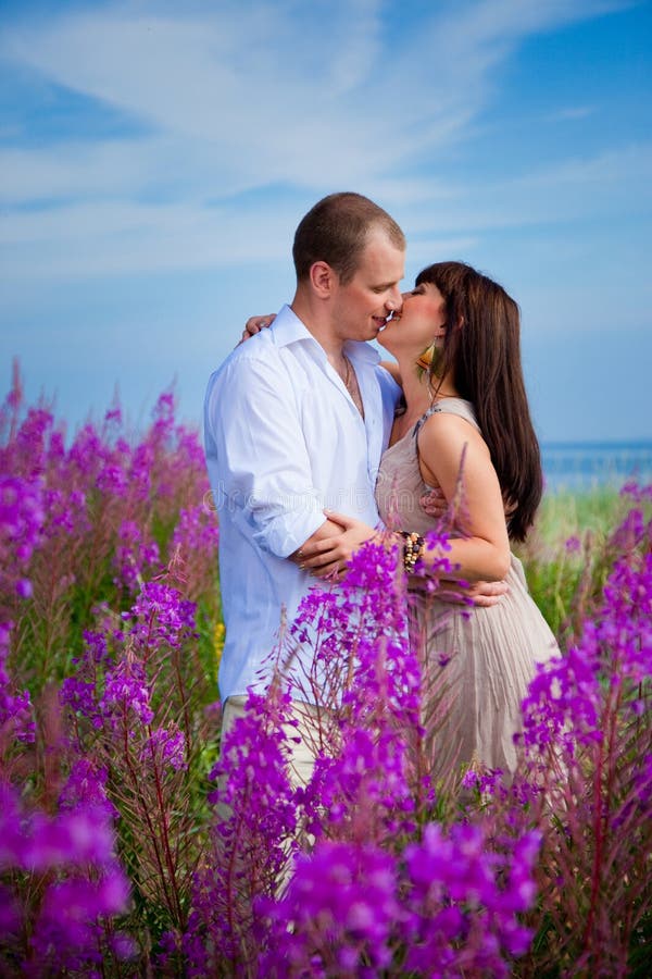 Kissing The Flower In Bloom Romantic Kiss among Purple Flowers Stock Photo - Image of close