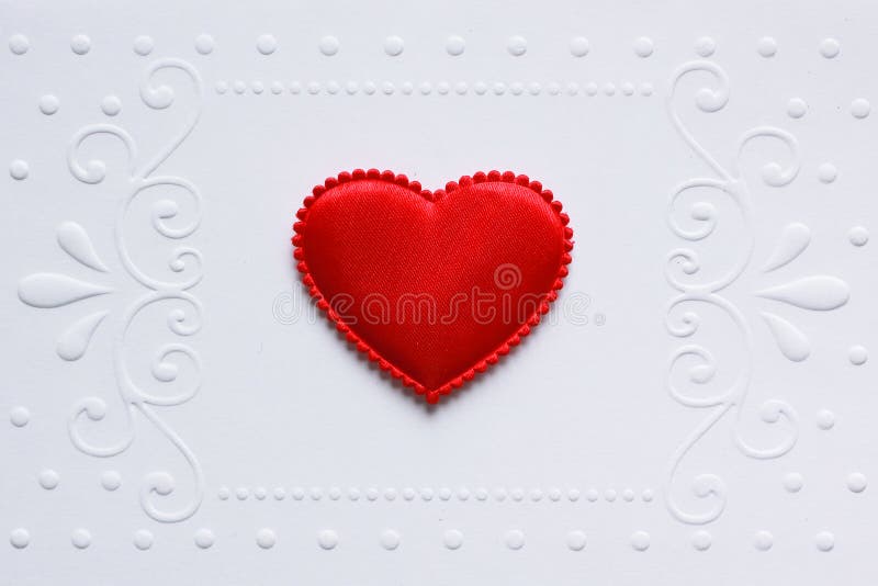 Blank embossed white paper with red satin hearts on it. Blank embossed white paper with red satin hearts on it.