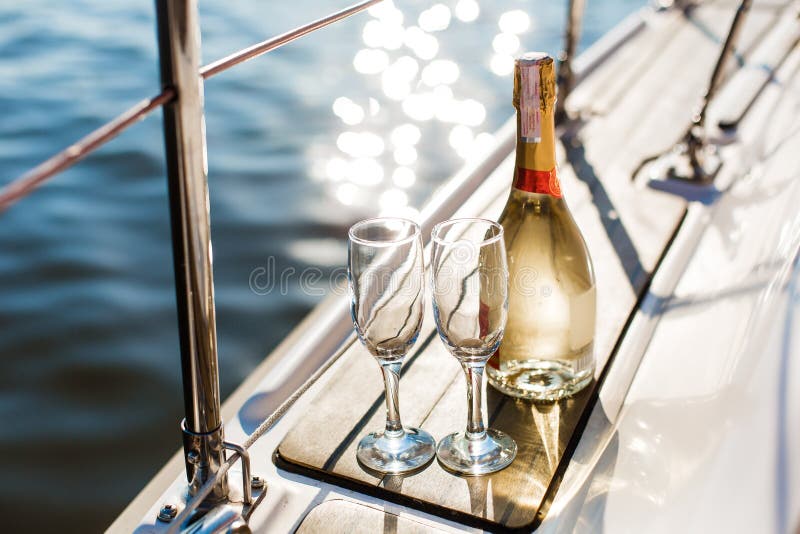 Empty glasses and bottle with champagne with sea background royalty free stock photos Empty glasses and bottle with champagne with sea background royalty free stock photos