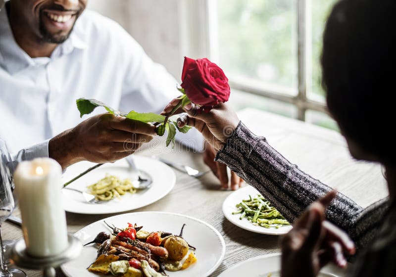 Romantic Man Giving a Rose To Woman on a Date Stock Photo Image of