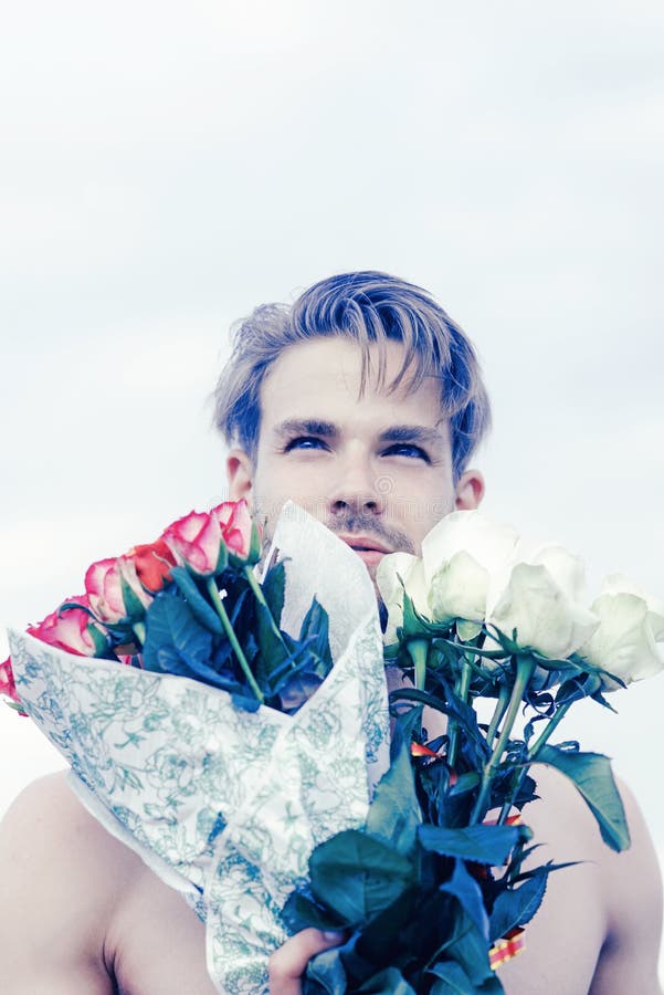 Romantic man with rose bouquet. valentines day present. gift with love. ready for date. muscular macho man with flowers stock photos Romantic man with rose bouquet. valentines day present. gift with love. ready for date. muscular macho man with flowers stock photos