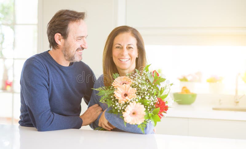 Romantic Middle Age Couple Holding Flowers In Love At Home Stock Image Image Of Affection