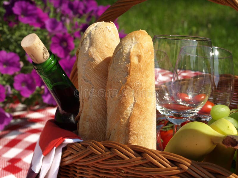 Aesthetic picnic outdoors with wine glasses bread berries and flowers.  Rustic picnic with neutral tones colours. Stock Photo by  ©lamapacas.gmail.com 378791178