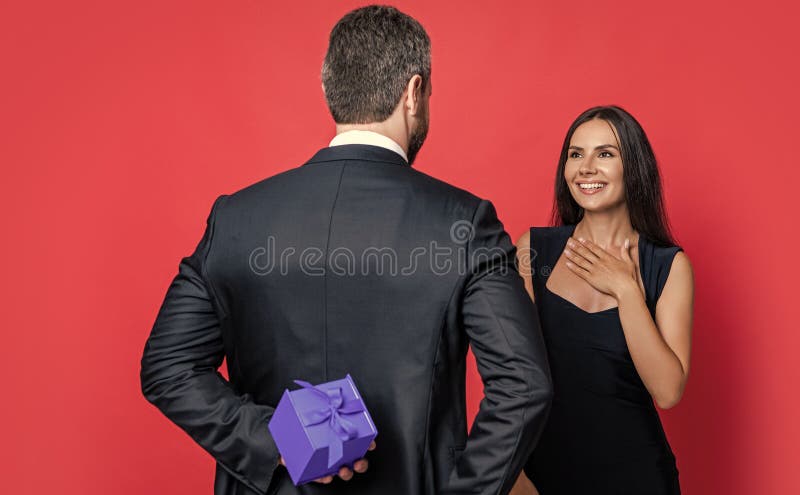 Romantic proposal with gift. Present. Man making proposal to woman. Man give present gift box for Valentines day to stock photo