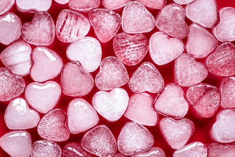 Romantic red background of hearts. Card with heart shaped ice. Texture, pattern. Symbol of valentine`s day.