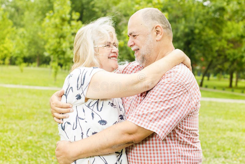 Romantic senior couple relaxing in the park. Joyful loving elderly couple stock images, royalty-free photos and pictures