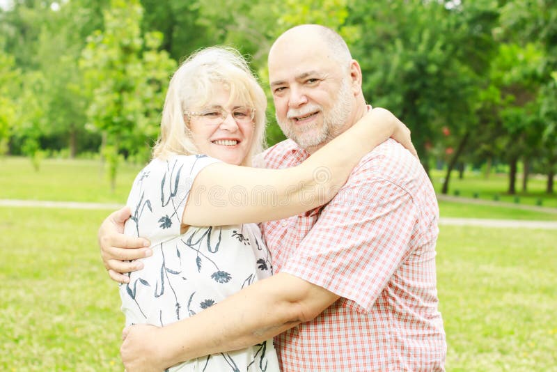Romantic senior couple relaxing in the park. Joyful loving elderly couple stock images, royalty-free photos and pictures