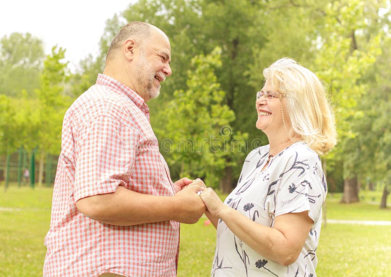 Romantic senior couple relaxing in the park. Joyful loving elderly couple stock images, royalty-free photos and pictures