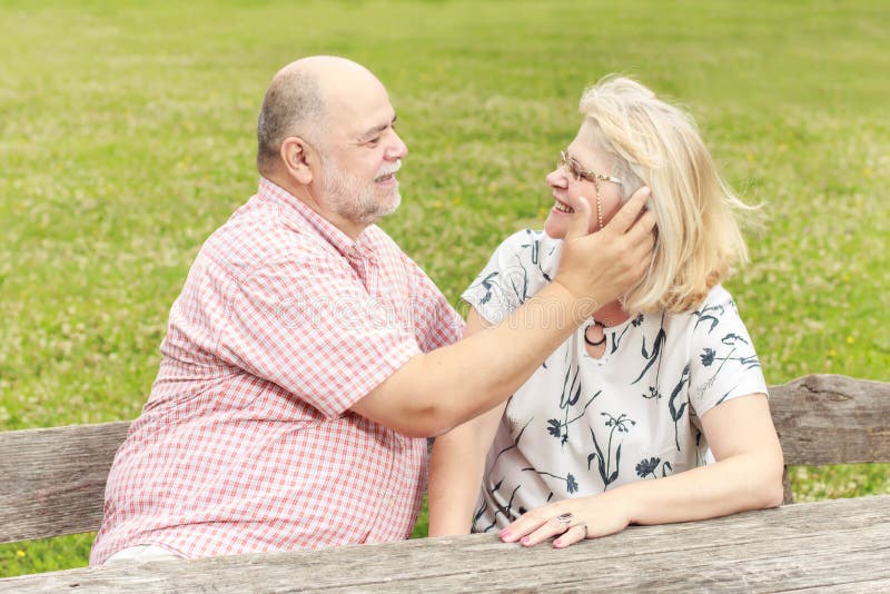 Romantic senior couple relaxing in the park. Joyful loving elderly couple stock images, royalty-free photos and pictures