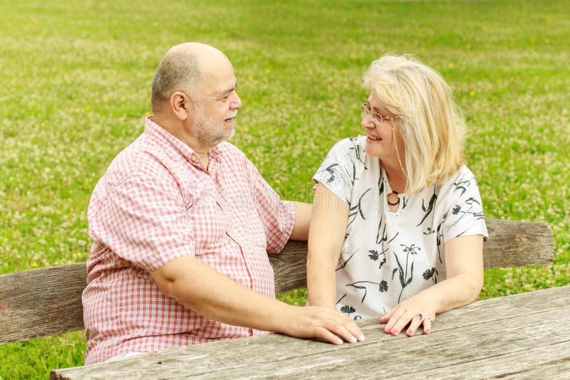 Romantic senior couple relaxing in the park. Joyful loving elderly couple stock images, royalty-free photos and pictures