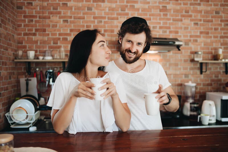 Romantic Young Couple Drinking Coffee Together in the Kitchen Stock