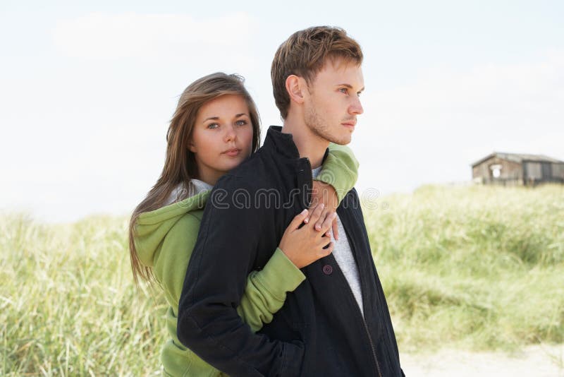 Romantic Young Couple Standing By Dunes