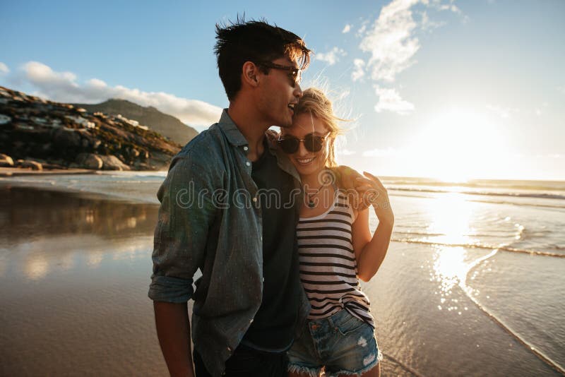 Romantic young couple standing together on beach stock photography Romantic young couple standing together on beach stock photography