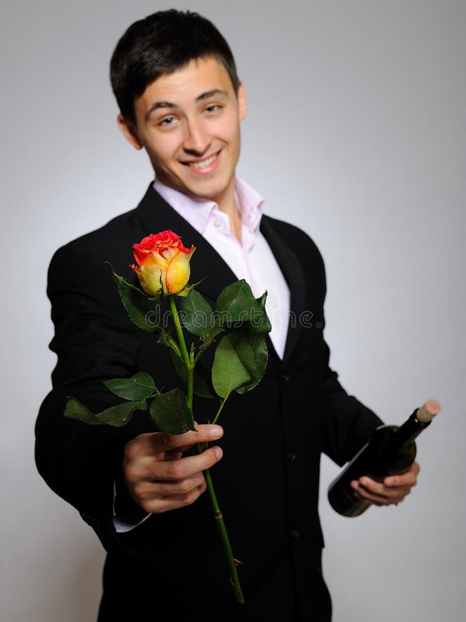 Romantic young man with flowers on a date
