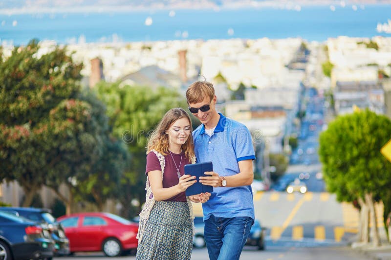 Romantiska par av turister som använder minnestavlan i San Francisco, Kalifornien, USA arkivfoto Romantiska par av turister som använder minnestavlan i San Francisco, Kalifornien, USA arkivfoto